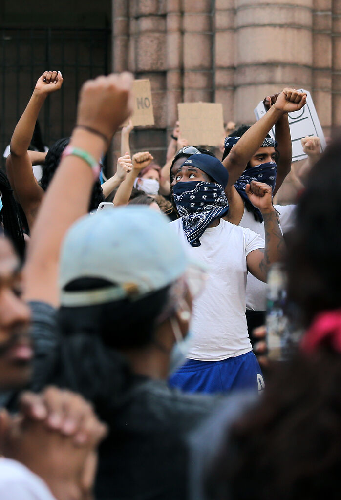 A demonstrator looks to the sky during a peaceful protest against the police killing of George Floyd